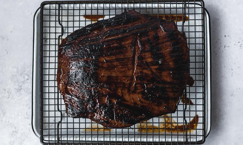 cooked steak on resting tray