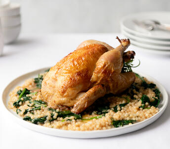roast spring chicken (poussin) with giant couscous cooked