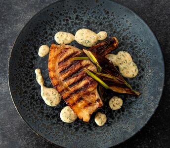 cooked pork chop, burnt leeks & mustard