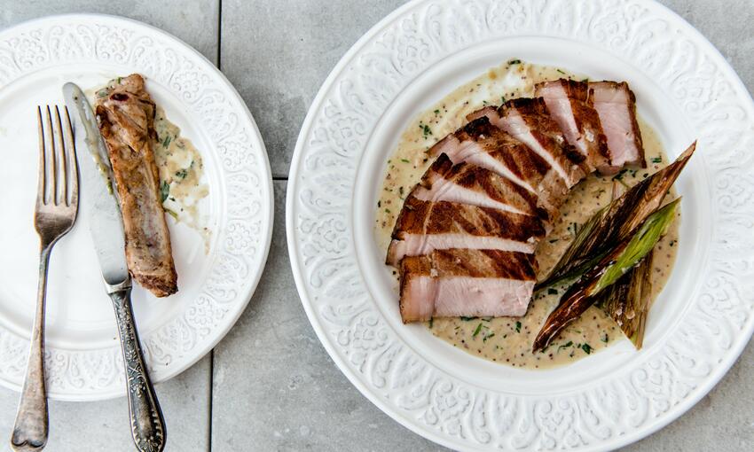 cooked pork chop, burnt leeks & mustard